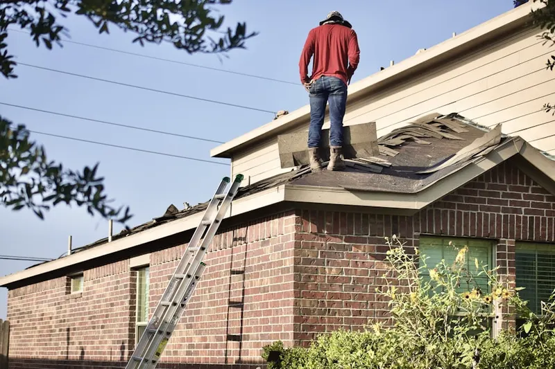 Professional roofer working on a residential roof in Fischers Crossroad